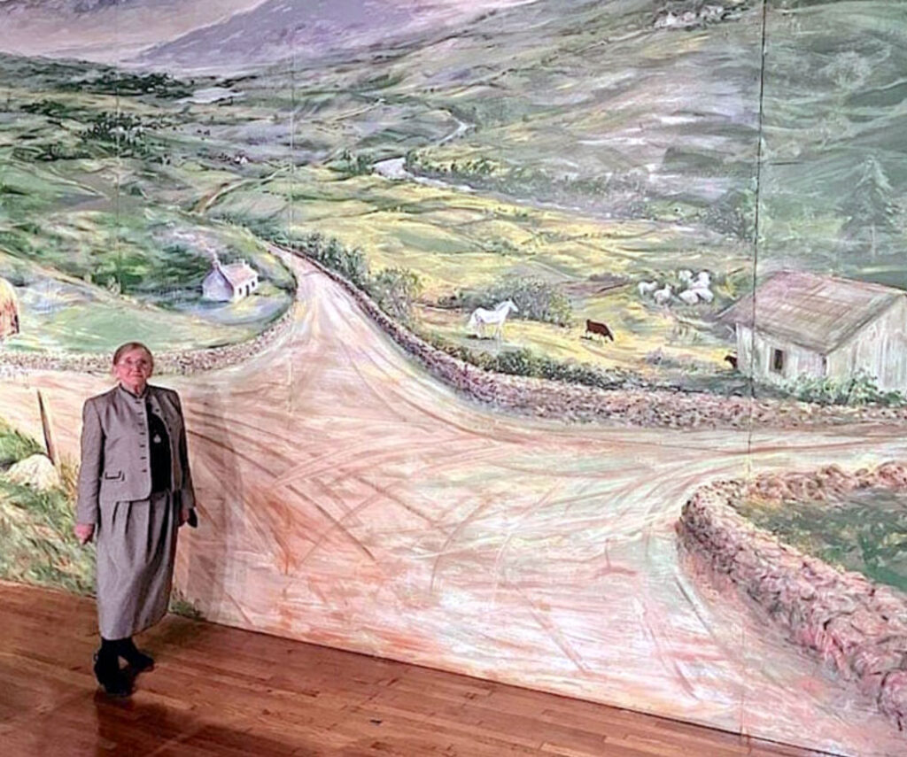 Janet Mcshain with Crossroads mural